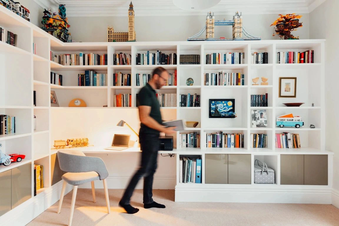 homepage image from the Freebird Interiors website featuring a white media wall display storage unit in a home office